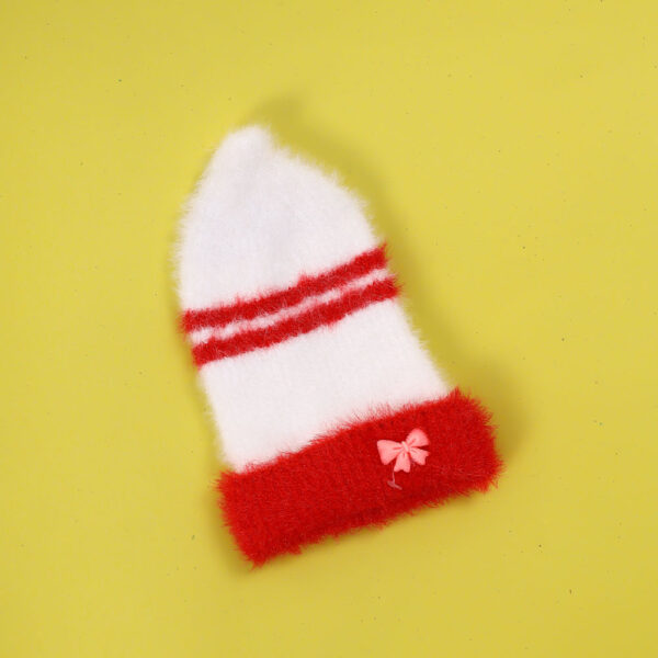 White knit hat with red stripes and a pink bow