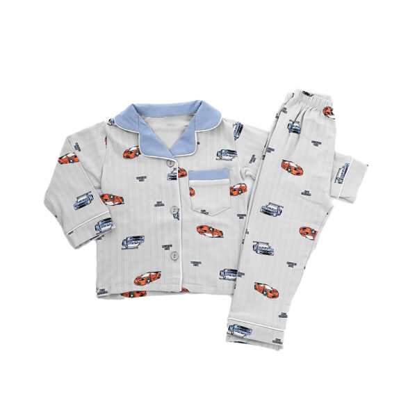 A light grey children's pajama set with a car print, displayed on a mannequin. The set includes a long-sleeved button-up top with a blue collar and piping, and long pants.
